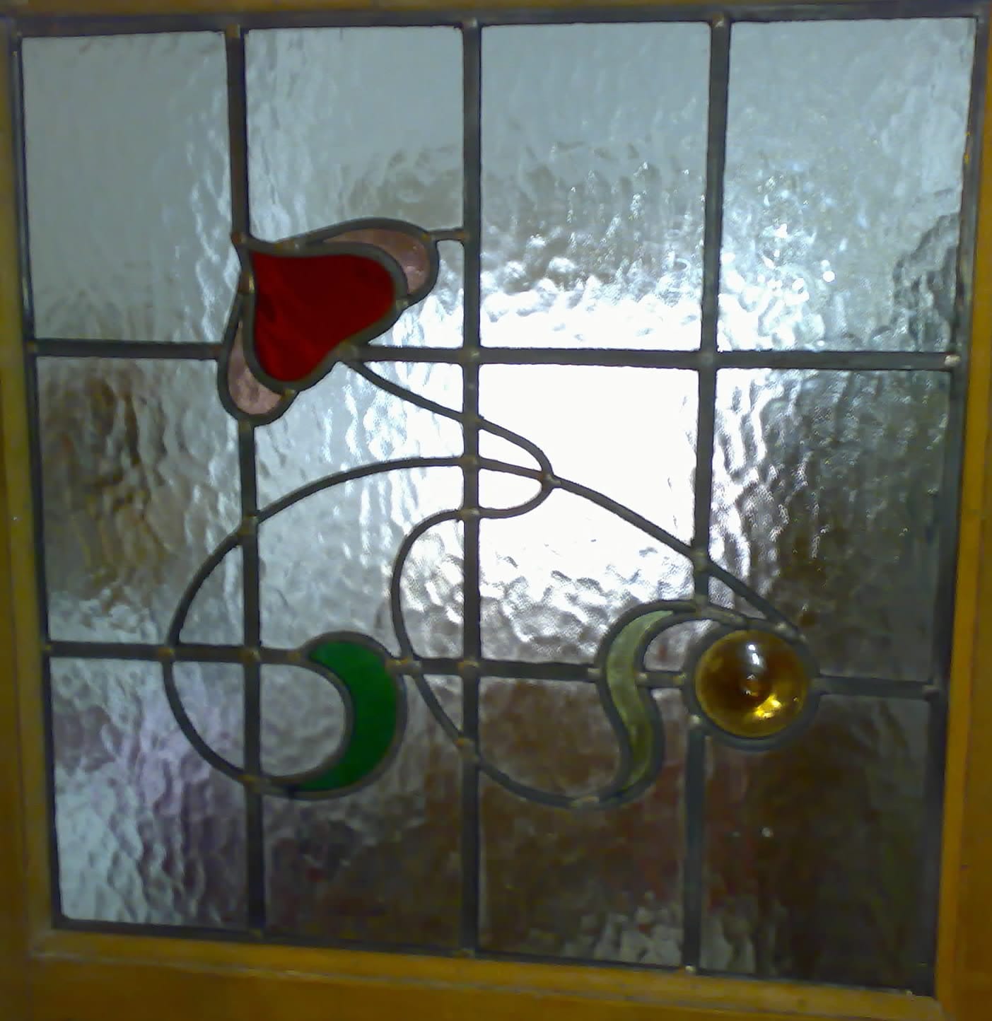 Art Nouveau stained glass panel with poppy and flowing stem motif