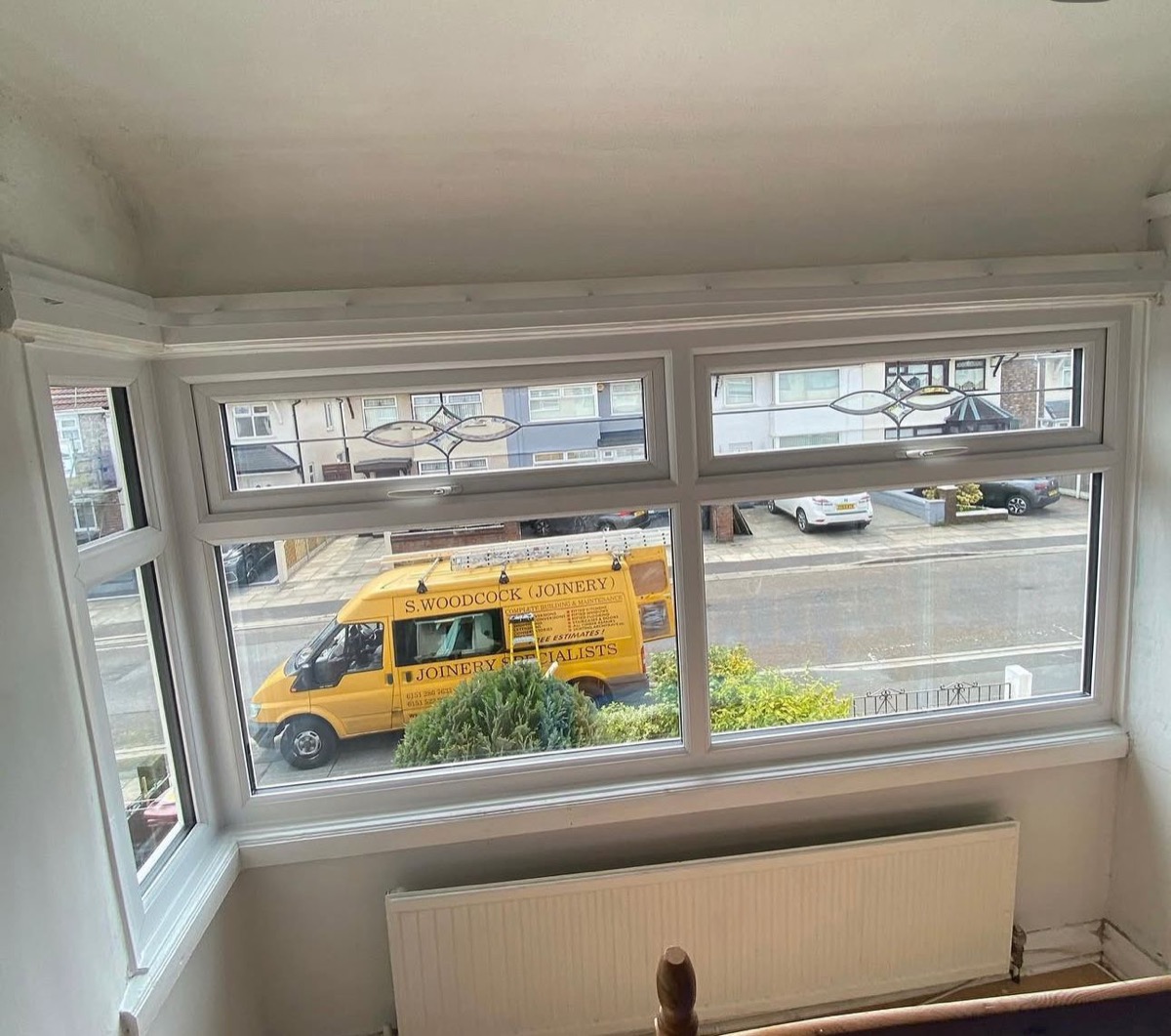 White bay window with leaded fanlight, branded joinery van outside