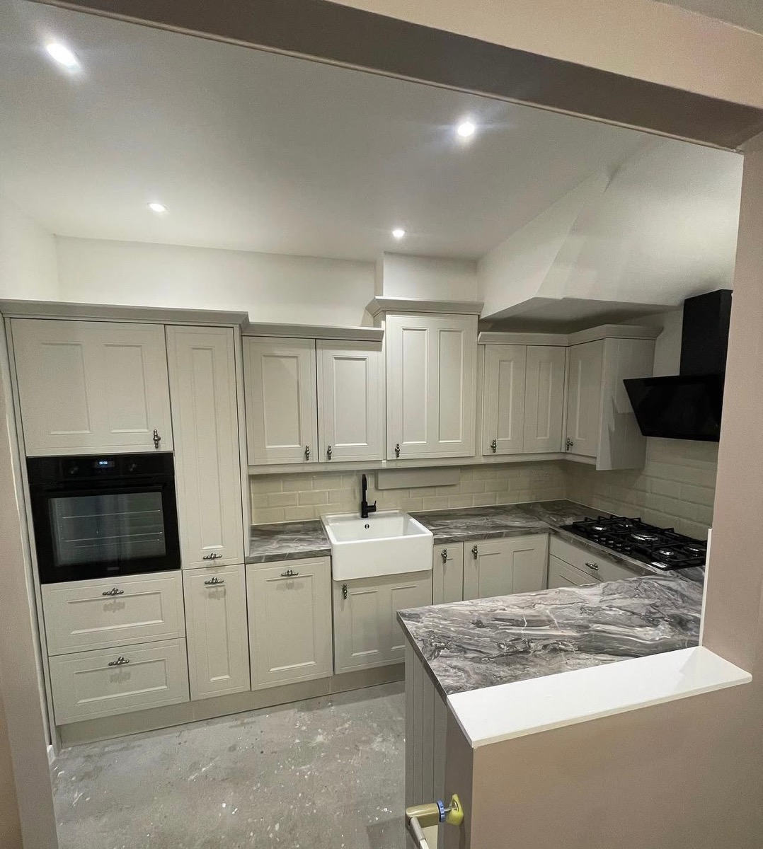 Grey shaker kitchen close-up with Belfast sink and chrome fittings
