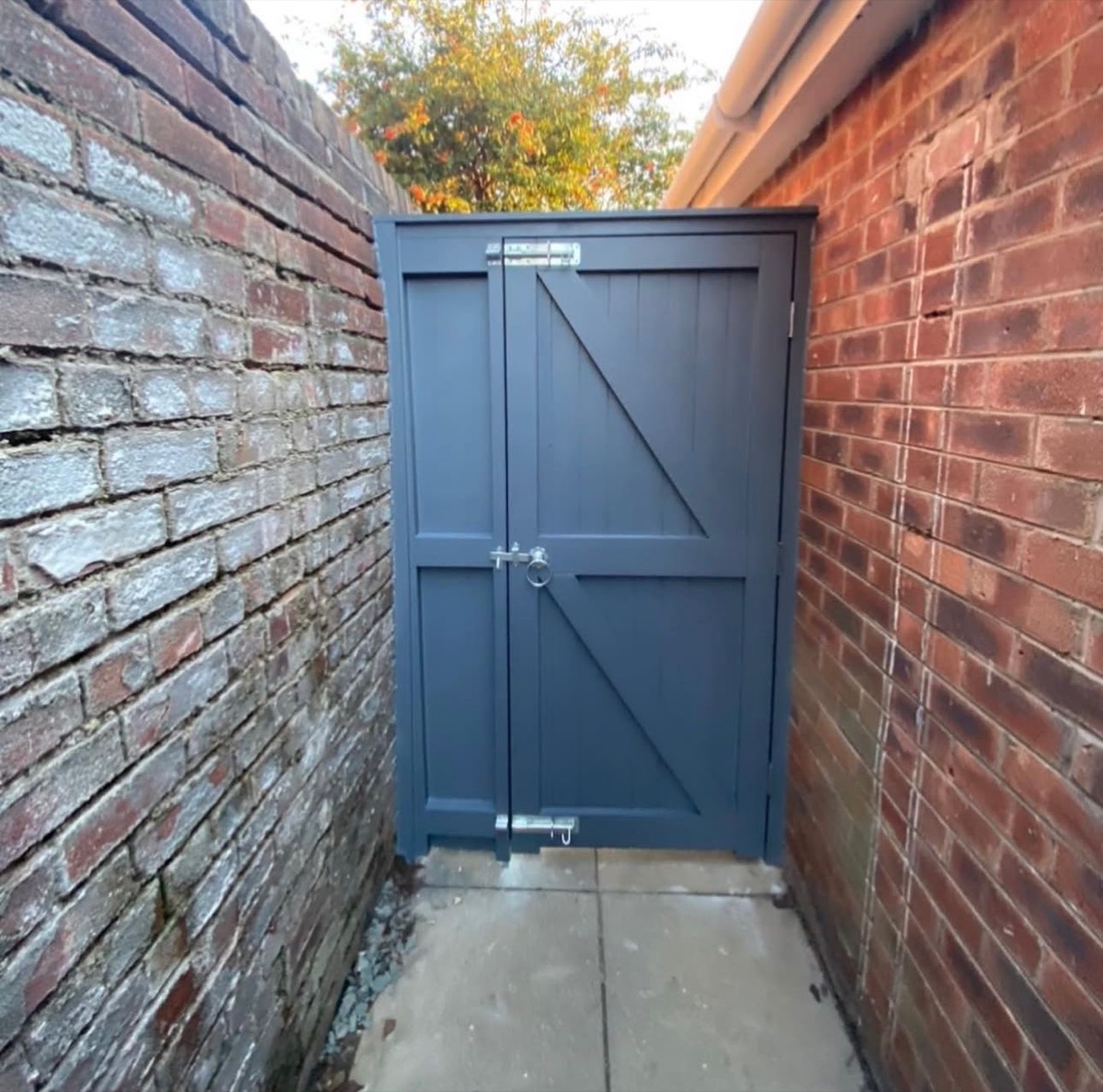 Navy painted bespoke double timber gate in brick alleyway, Liverpool