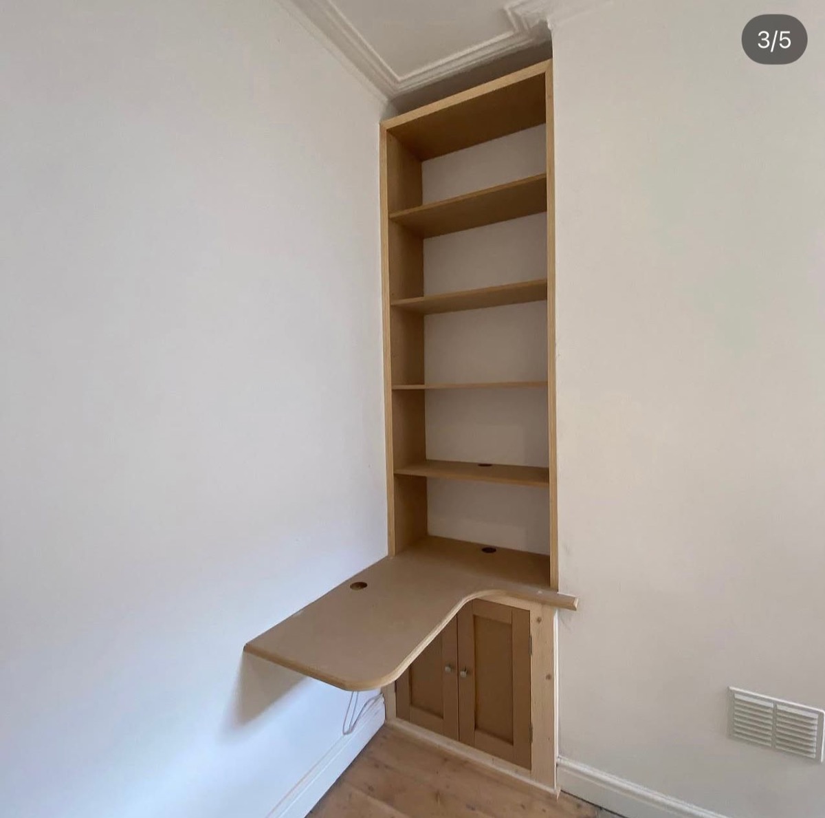 Oak fitted alcove bookcase with wall-mounted desk and storage cupboard