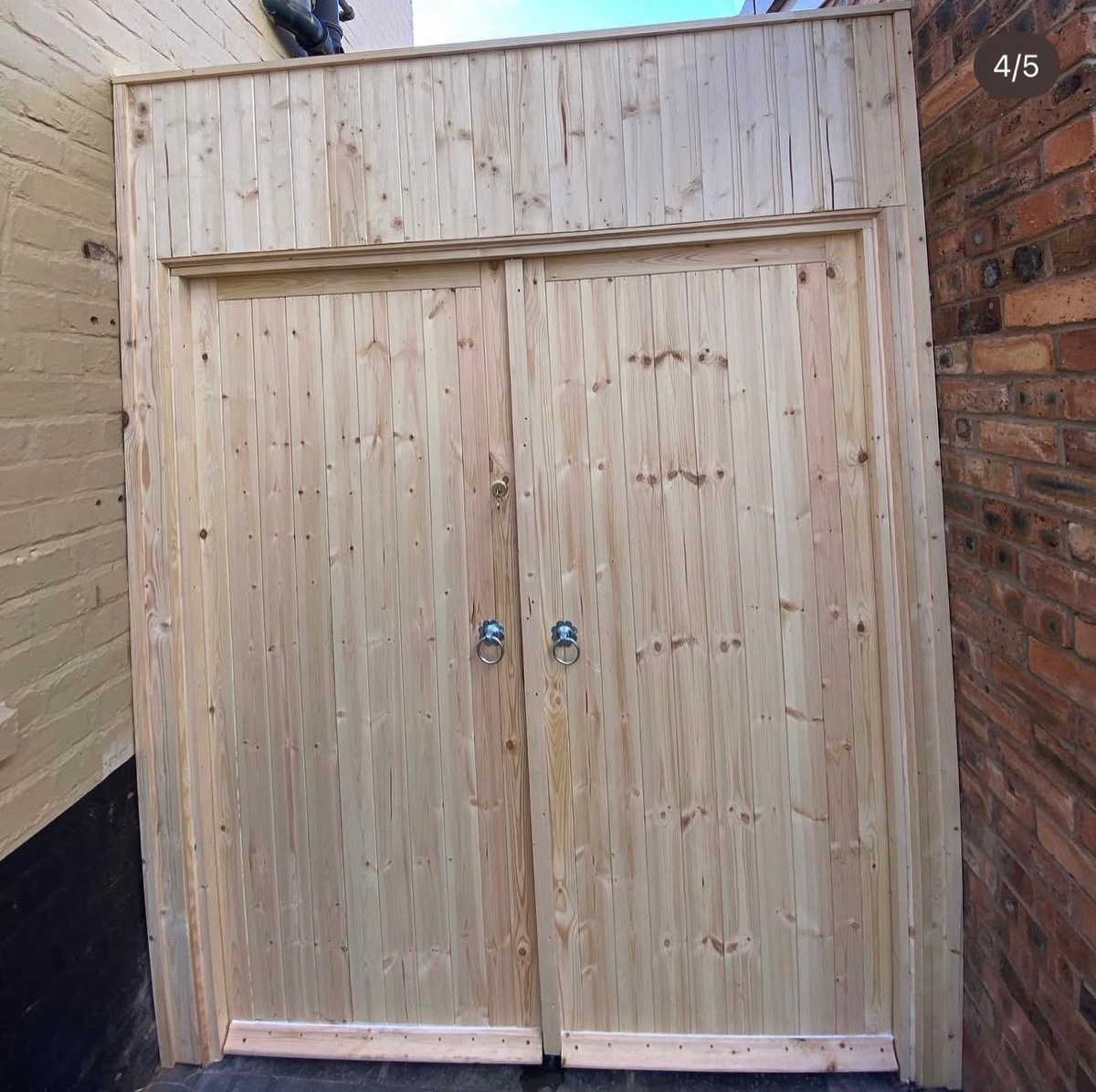Natural pine bespoke double doors with glazed fanlight panel above