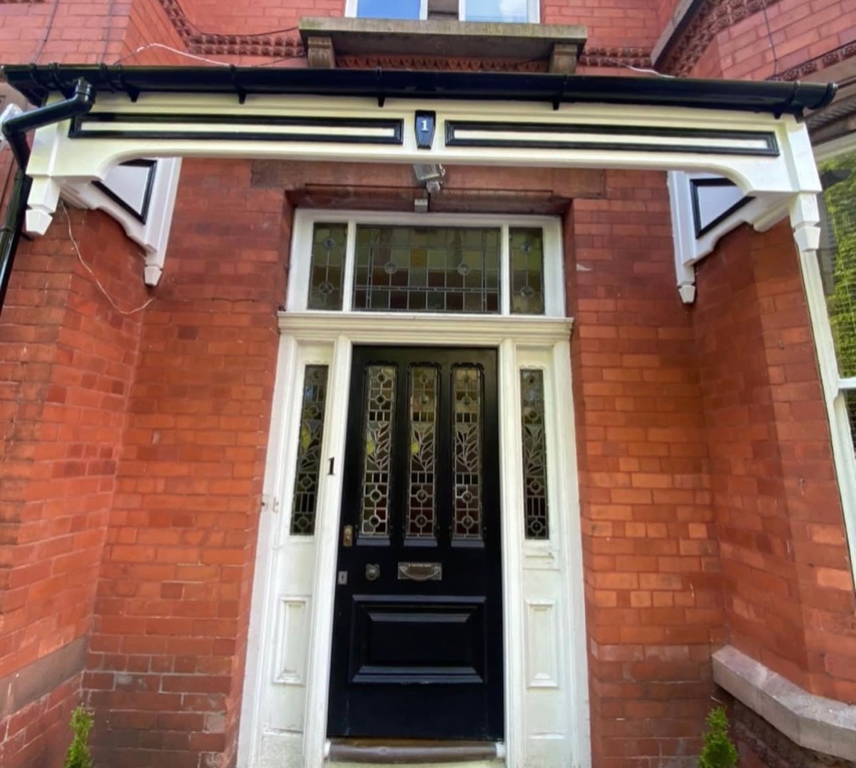 Victorian entrance with ornate timber canopy and stained glass fanlight, Liverpool
