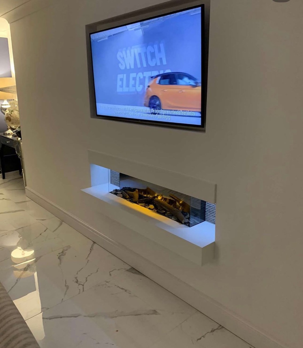 Minimalist white fitted media wall with integrated bio fireplace, Liverpool