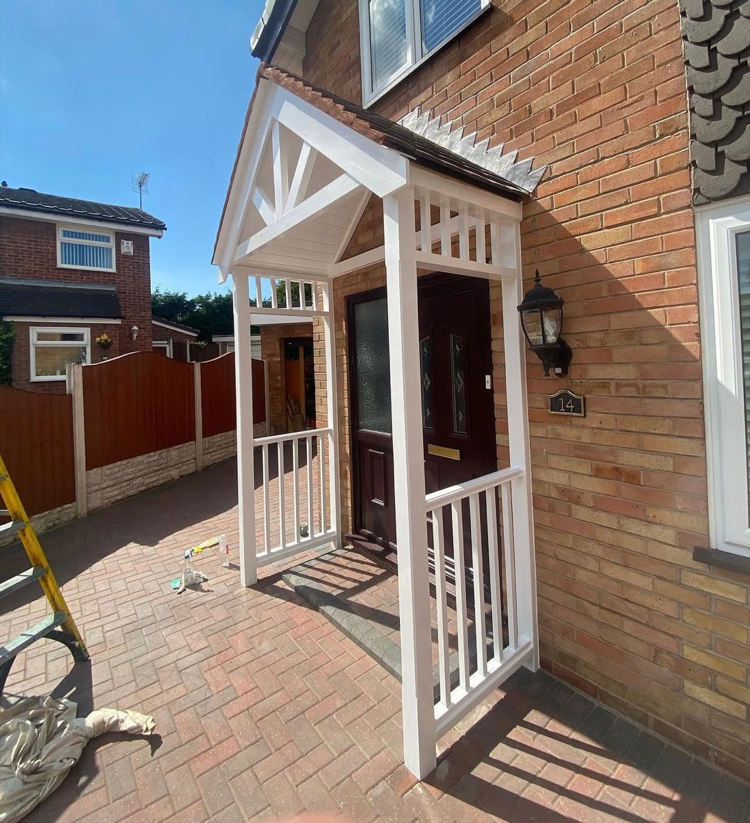 White timber porch with gabled roof and spindle railing, Liverpool