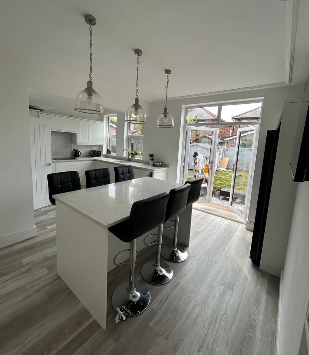 Bespoke white shaker kitchen with marble island and pendant lights, Liverpool joinery