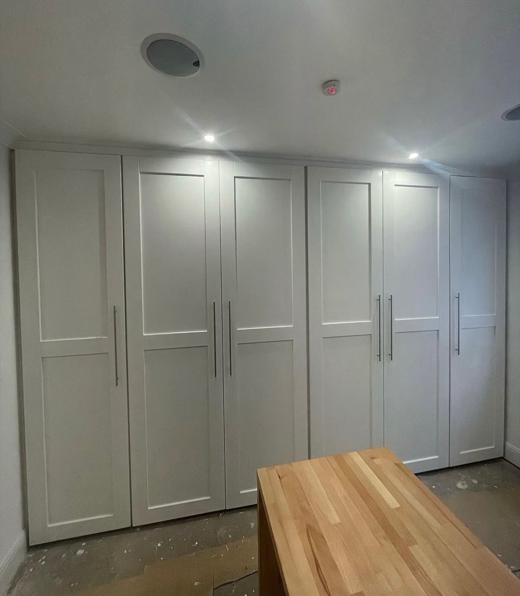 White fitted wardrobes in sloped ceiling alcove, bespoke joinery Liverpool