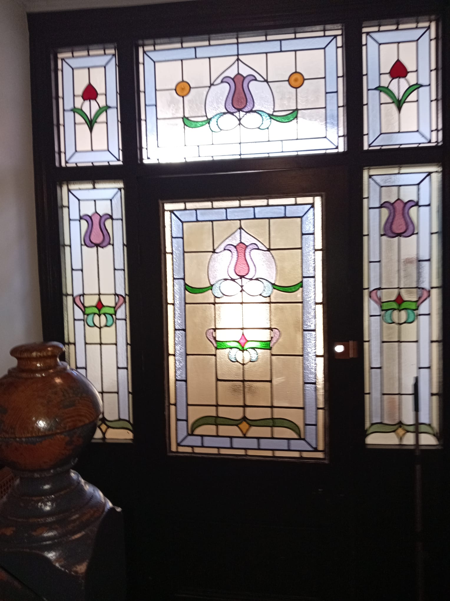 Victorian front door with matching tulip stained glass panels and sidelights