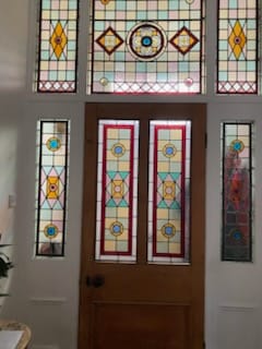 Victorian front door with multicoloured leaded light glazing and sidelights