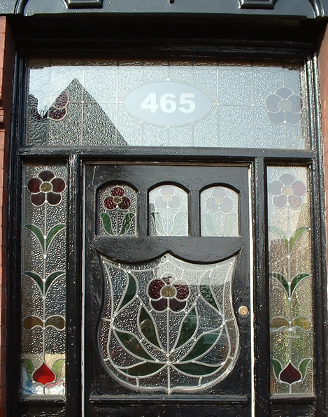 Victorian front door with ornate stained glass panels and floral design
